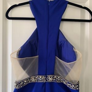 Cobalt fitted dress. Rhinestone belt. Illusion on sides. Flares out at bottom.